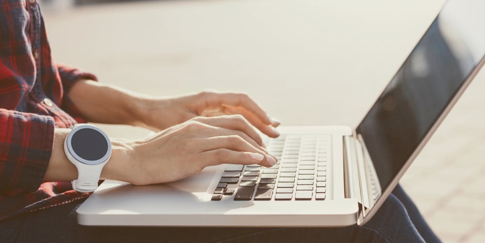 person typing on a laptop