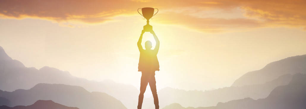 Image of man holding up a trophy