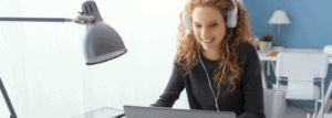 Woman sitting at a desk, learning online.