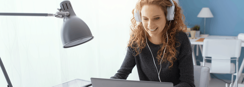 Woman sitting at a desk, learning online.