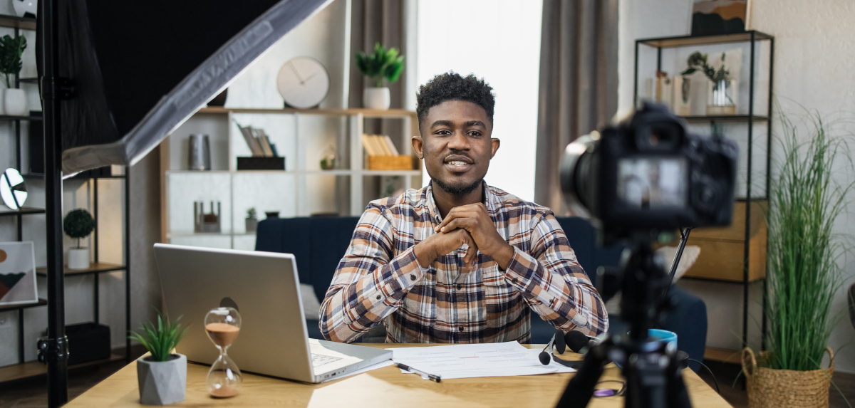 Man recording video on camera at home