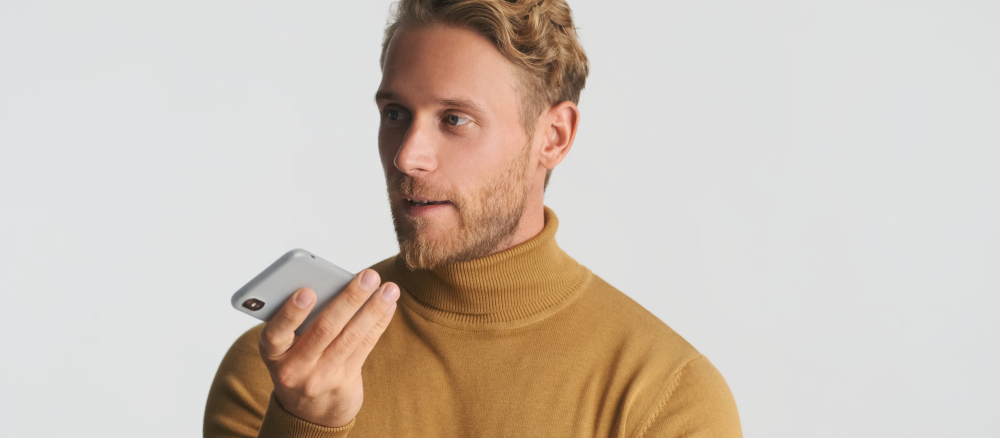 Man recording into a phone.