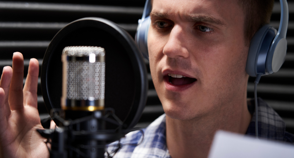 Man recording and reading from a script.