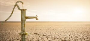 Dry cracked desert with old water pipe